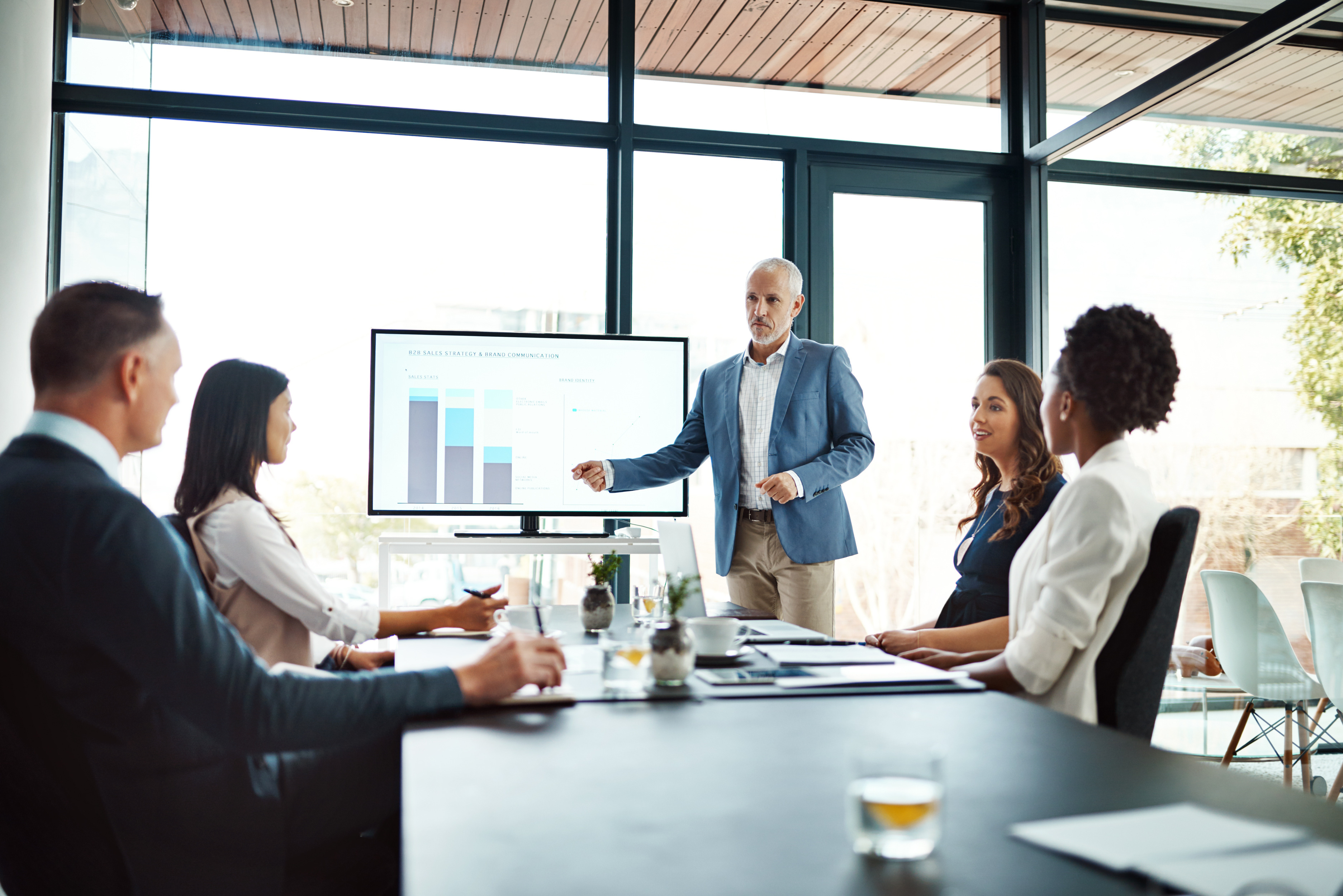Man giving a presentation to a board table